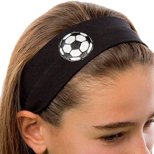 May include: Black headband with a white soccer ball graphic. The headband is made of a soft, stretchy fabric and is perfect for keeping hair out of your face during sports or exercise.