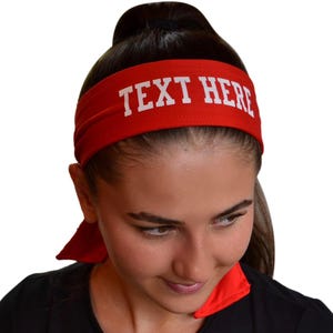 May include: Red headband with white text that says "TEXT HERE".