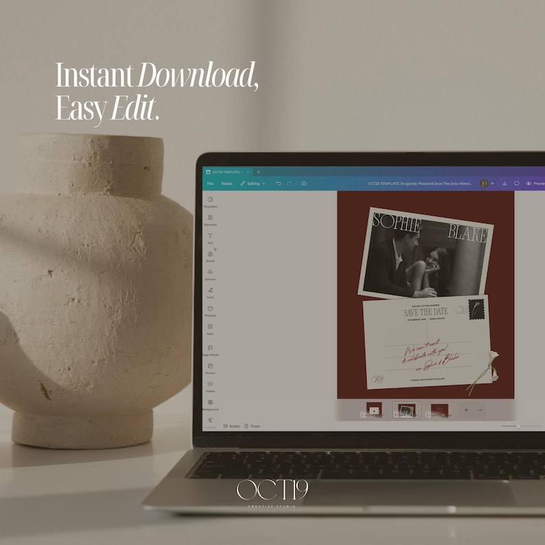 May include: A laptop displaying a digital design interface for a Save the Date postcard template featuring a black and white photograph of a couple, the text Sophie Blake, and the words Save the Date, next to a large, textured, beige ceramic vase.