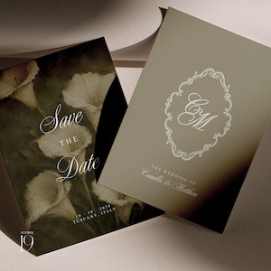 May include: Two rectangular wedding stationery cards. One card features a dark, moody floral print of white calla lilies with the text Save The Date, 19 10 2028, and TUSCANY, ITALY. The other card is sage green with a white ornate frame and the initials CM.