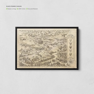 May include: A black framed canvas featuring a detailed, sepia-toned illustrated map titled CAT VIEW. The map depicts a landscape with mountains, forests, and buildings, including a legend labeled KEY TO THE CLANS and a compass rose pointing north.