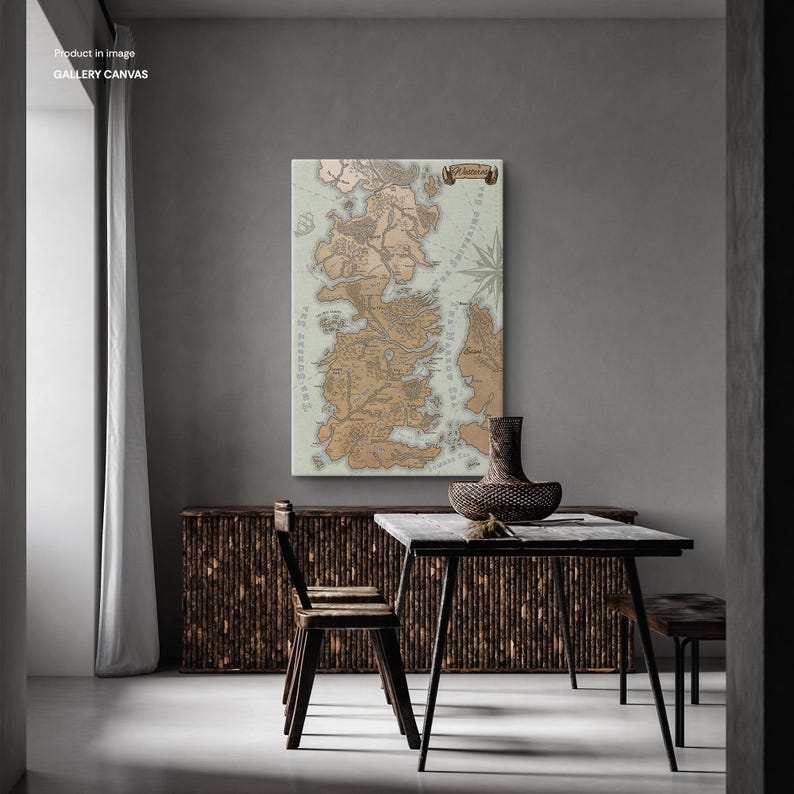 May include: A vintage-style map of Westeros, the fictional continent from the Game of Thrones series, printed on a canvas. The map is framed and hanging on a wall in a room with a wooden table and chairs.