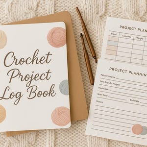May include: A crochet project log book with the title "Crochet Project Log Book" in brown script. The cover features watercolor illustrations of yarn balls in beige, pink, and grey. Project planning sheets and crochet hooks are also visible.