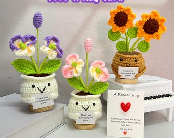 May include: A collection of handmade crochet flower arrangements in small pots. The flowers include purple and white pansies, pink and white flowers, and sunflowers. Each pot has a smiling face and a small card that says "Thank you for helping me grow."