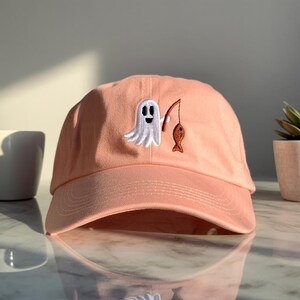 Premium Personalized Ghost Fishing Dad Hat – Embroidered Ghost Holding Fish – Adjustable Cotton Cap Gift