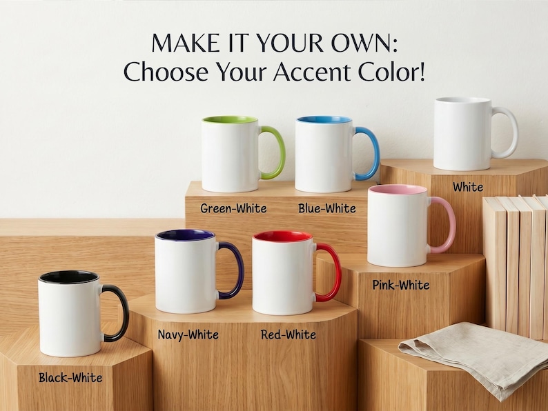 May include: A collection of white ceramic mugs with various accent colors, including green, blue, pink, red, navy, and black. The mugs are displayed on wooden blocks, with text above that reads "MAKE IT YOUR OWN: Choose Your Accent Color!"