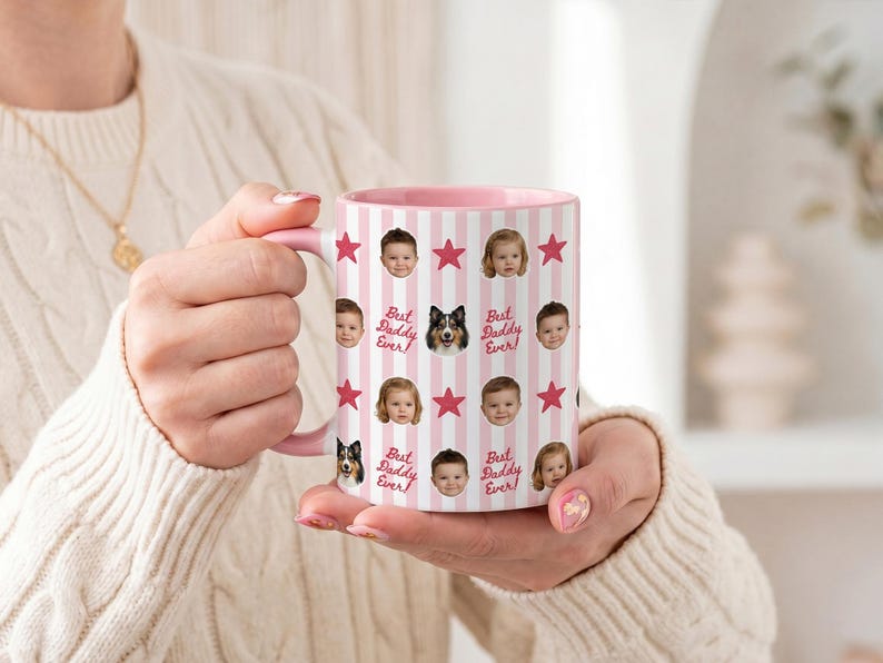 May include: A pink and white striped mug with a pink handle and interior. The mug is decorated with photos of children, a dog, and the text "Best Daddy Ever" and red stars. The mug is held by a person.