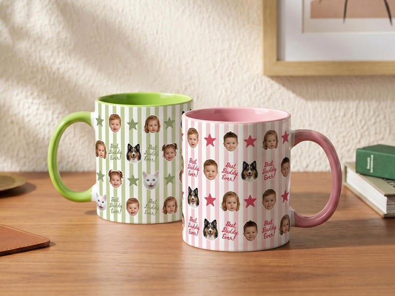 May include: Two ceramic mugs with colorful designs. One mug has a green handle and interior, the other has a pink handle and interior. Both mugs feature a pattern of faces, stars, and the text "Best Daddy Ever!"