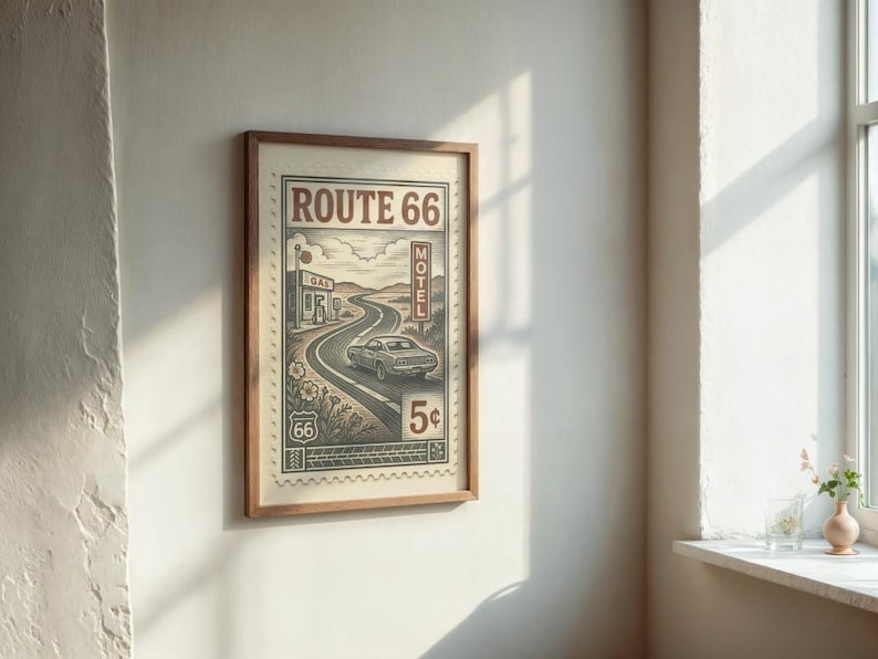 May include: Framed vintage-style Route 66 print. The artwork features a winding road, a classic car, and the text "Route 66" in a retro design. The print is in a wooden frame and is displayed on a white wall.