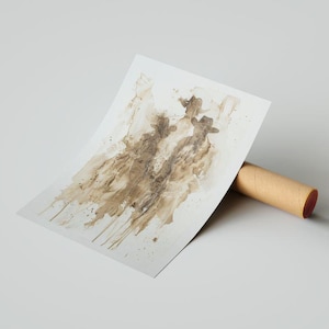 May include: An abstract print depicting three figures in hats, rendered in shades of brown. The artwork is displayed on white paper, supported by a brown cardboard tube. The background is neutral.