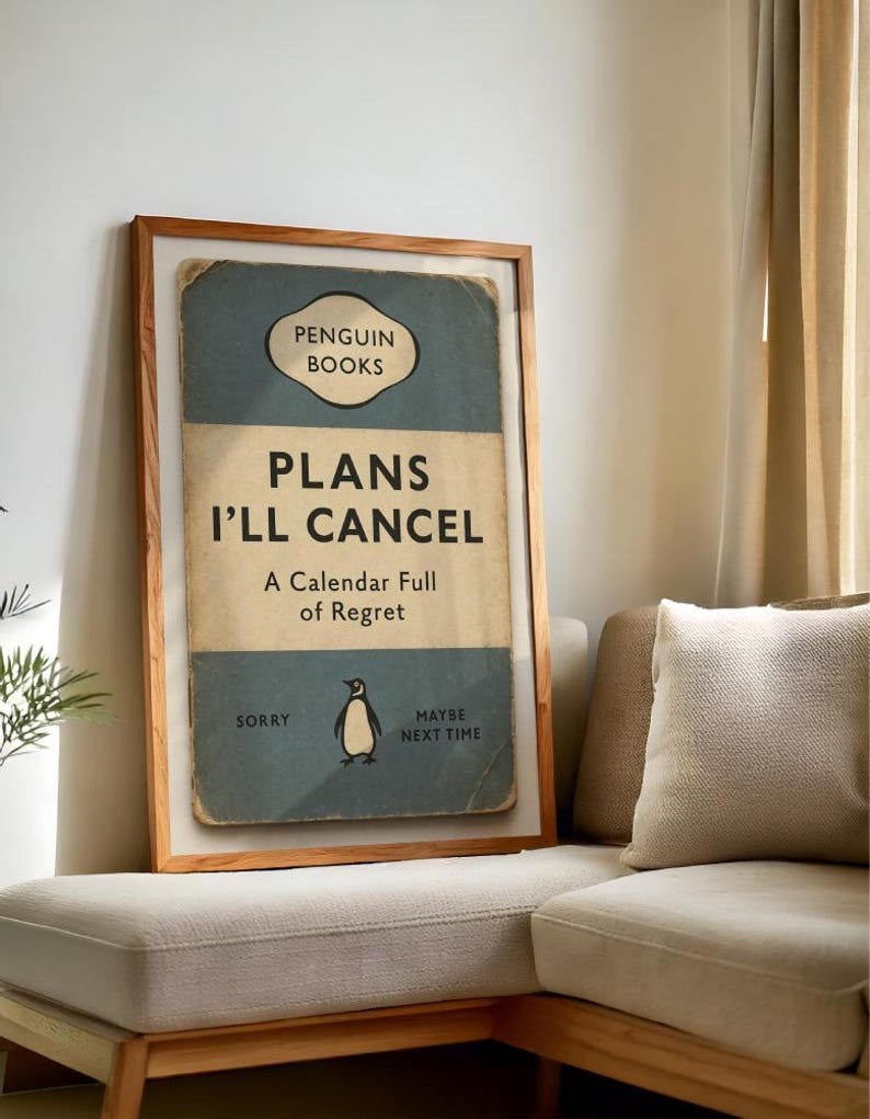 May include: A framed print with a vintage book cover design. The text reads "PLANS I'LL CANCEL" with "Penguin Books" at the top. A penguin illustration is featured, with the phrases "Sorry" and "Maybe Next Time".