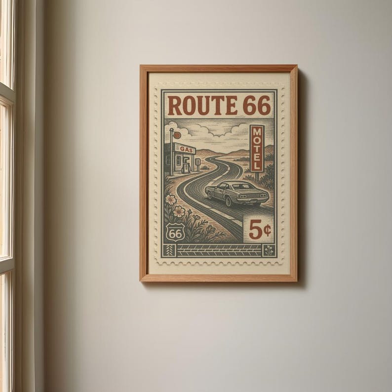 May include: Framed Route 66 art print. The artwork features a vintage design with a winding road, a classic car, and the text "Route 66". The print includes a gas station, motel sign, and the number "5&cent;".