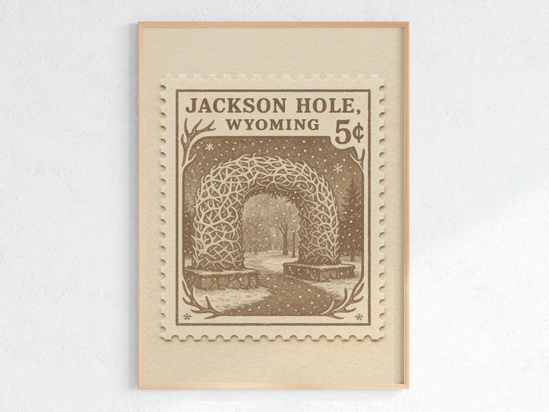 May include: Framed print featuring a vintage-style postage stamp design. The stamp depicts an archway made of intertwined branches, with the text "Jackson Hole, Wyoming" and a "5&cent;" value. The artwork is in sepia tones, suggesting a nostalgic aesthetic.