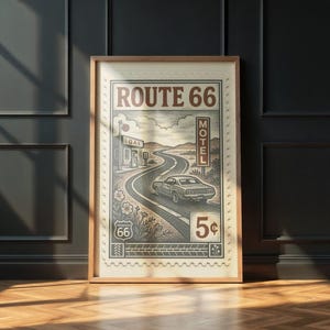 May include: Framed vintage-style print featuring a winding road, a classic car, and the text "ROUTE 66". The artwork includes a gas station, motel sign, and a 5&cent; stamp design. The color palette is primarily sepia tones.