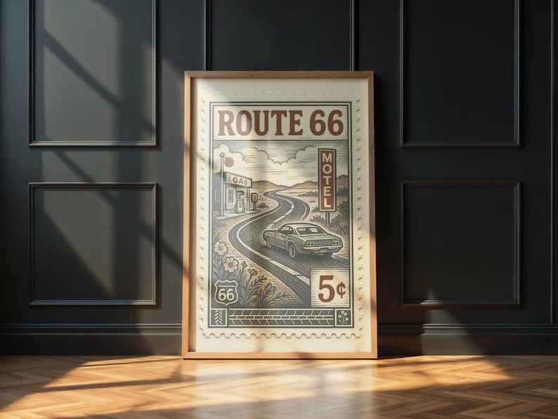 May include: Framed vintage-style print featuring a winding road, a classic car, and the text "ROUTE 66". The artwork includes a gas station, motel sign, and a 5&cent; stamp design. The color palette is primarily sepia tones.