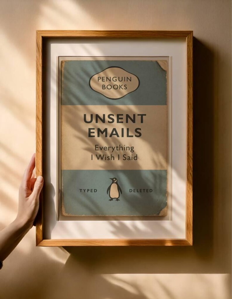 May include: A framed print with the text "UNSENT EMAILS Everything I Wish I Said" from Penguin Books. The print features a vintage design with a penguin illustration and is encased in a wooden frame.