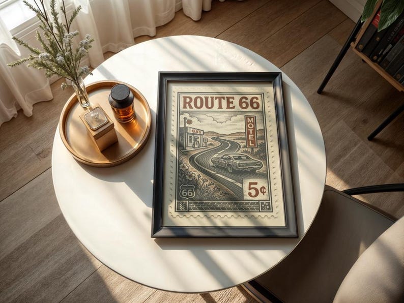 May include: Framed Route 66 print with a black border. The vintage-style artwork depicts a car driving on a winding road, with the words "Route 66" at the top. The print also includes a gas station, motel, and the number "5&cent;".