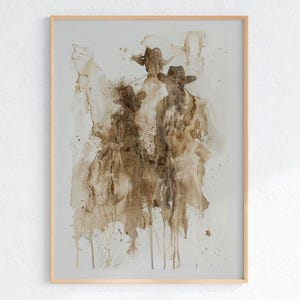May include: Abstract art print depicting three figures in cowboy hats and coats, in shades of brown and beige. The artwork is framed in a light wood frame, creating a rustic aesthetic.