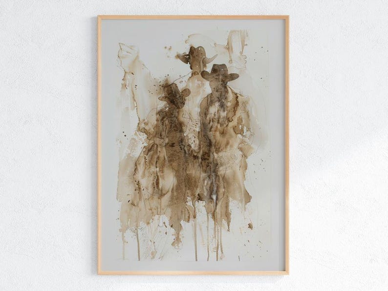 May include: Abstract art print depicting three figures in cowboy hats and coats, in shades of brown and beige. The artwork is framed in a light wood frame, creating a rustic aesthetic.