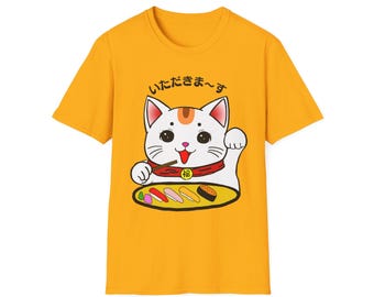May include: A yellow t-shirt with a white cat eating sushi. The cat is wearing a red bib with the Japanese character for "luck" on it. The text on the shirt says "Itadakimasu", which is Japanese for "I humbly receive".