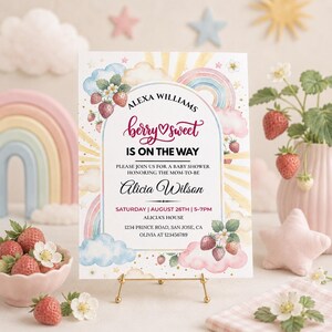 Puede incluir: Una tarjeta de invitación rectangular para baby shower con ilustraciones en acuarela de fresas, nubes y un arcoíris. El texto dice: Alexa Williams, berry sweet is on the way, please join us for a baby shower honoring Alicia Wilson.