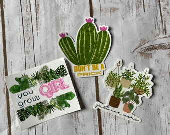 May include: Three stickers with plant-themed designs. One sticker features a green cactus with pink flowers and the text "DON'T BE A PRICK". Another says "you grow GIRL" with green leaves. The last sticker shows potted plants and the text "just one more".
