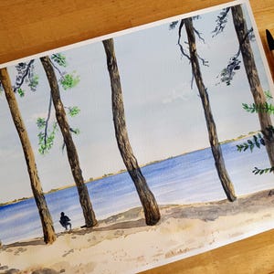 May include: A watercolor painting on paper depicting a landscape with five tall, slender tree trunks in the foreground, a sandy beach, and a blue lake in the background. A small silhouette of a person sits on a chair near the water's edge.