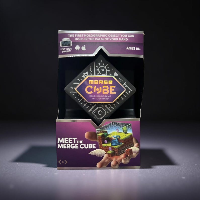 Merge Cube interactive hologram toy in retail packaging, showing a cube that creates 3D holograms when used with a smartphone app.