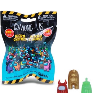Among Us micro collectible figures with three small character figures shown next to sealed blind bag packaging.