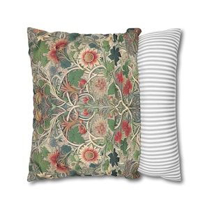 May include: Two decorative pillows. One square pillow features a floral pattern with red, green, and beige tones. The other is a long, rectangular pillow with gray and white stripes. Both pillows are on a white background.
