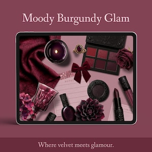 May include: A digital tablet showcases burgundy-themed beauty products. The image includes an eyeshadow palette, lipstick, nail polish, a ring, a bow, a candle, and a decorative flower. The text "Moody Burgundy Glam" is at the top of the image.