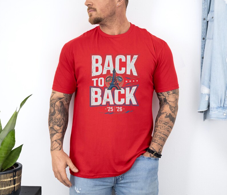 A man wearing a red t-shirt with the text "BACK TO BACK" and a graphic of the Eiffel Tower.