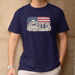 A navy blue t-shirt with a graphic design featuring the Statue of Liberty and George Washington on the front.