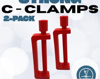 May include: Two red C-clamps with threaded rods and adjustable handles. The image includes the text "STRONG C-CLAMPS 2-PACK" in black and blue, and "Quality Products" in black. A logo for Lancaster Laser is in the bottom right corner.