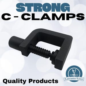 May include: A black C-clamp with the text "STRONG C-CLAMPS" in blue and black. The clamp has a threaded screw for adjusting the grip and the words "Quality Products" are at the bottom.
