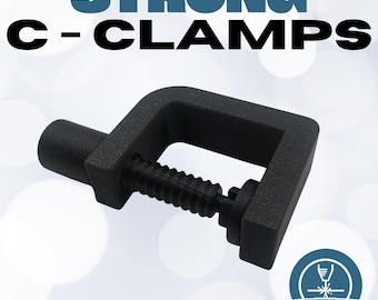 May include: A black C-clamp with the text "STRONG C-CLAMPS" in blue and black. The clamp has a threaded screw for adjusting the grip and the words "Quality Products" are at the bottom.