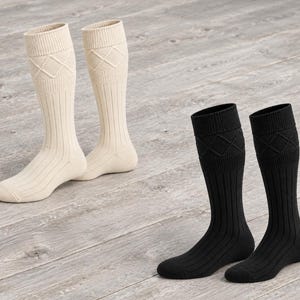 May include: Two pairs of knee-high socks, one pair in cream and one pair in black. Each sock features a ribbed knit texture throughout the leg and foot, with a distinct diamond-patterned knit design integrated into the wide, folded cuff at the top.