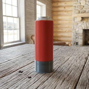 May include: A red and gray can cooler with a ribbed design. The cooler is cylindrical and made of a durable material. The top is silver, and the base is gray. The cooler is designed to keep beverages cold.
