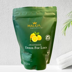 May include: A green pouch of "Detox For Locs" hair care product by Malkia Essentials. The package features a lemon graphic and text indicating it helps rid hair of dirt and product buildup. The product is labeled as 100% natural.