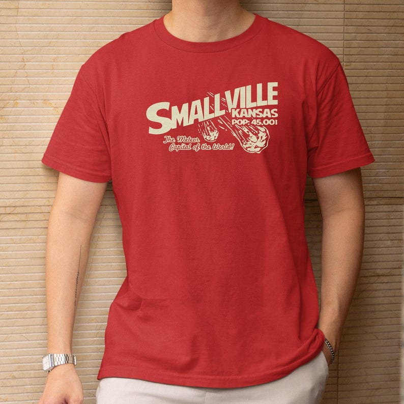 A red t-shirt with white text and graphics printed on it.