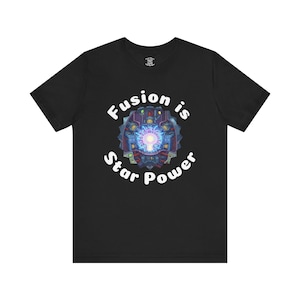 May include: Black t-shirt featuring the text "Fusion is Star Power" in white, encircling a vibrant graphic. The graphic has a central keyhole shape with a bright light, set within a detailed, mechanical design.