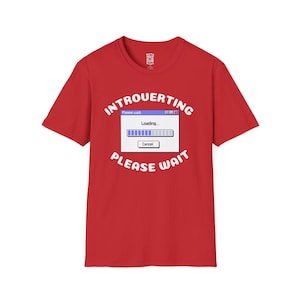 May include: Red t-shirt with the text "INTROUERTING PLEASE WAIT" in white, featuring a computer loading screen graphic. The graphic includes the word "Loading..." and a progress bar.