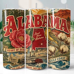 May include: A cylindrical tumbler featuring a vintage-style graphic of Alabama. The design includes the word ALABAMA in large red letters, a red camellia flower, a map of Alabama, a yellow bird, cotton bolls, a steamboat, and the text Sweet Home Alabama.