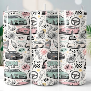 May include: A white tumbler featuring a repeating pattern of cartoon cars, car parts, and Japanese text. The design includes cars in various colors, steering wheels, and phrases like "JDM" and "Boost".