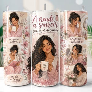 May include: A tumbler featuring watercolor illustrations of a woman in various relaxing poses, with text in Spanish. The design includes floral accents and butterflies, with a pink and white color scheme. The tumbler has a straw and a silver lid.