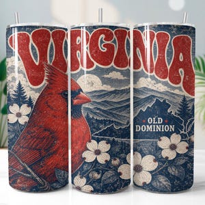 May include: A tumbler featuring a vintage design with the word "VIRGINIA" in red, a red cardinal, and the phrase "OLD DOMINION." The design includes mountains, trees, and white flowers against a blue background.