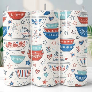 May include: Three white insulated tumblers with a patriotic design. The design features red, white, and blue bowls, stars, hearts, and fireworks. Text on the tumblers reads "Life, Liberty and Pyrex" and "Stars Stripes and Leftovers."