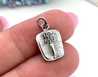 May include: A silver-toned metal charm shaped like a rectangular scale with a textured surface and a central handle. The charm features the embossed text "TOU FAT" on the upper portion of the scale face and includes a small jump ring at the top.