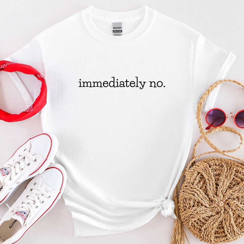 May include: White t-shirt with the text "immediately no." printed in black.