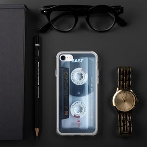 May include: A clear phone case with a vintage cassette tape design. The case features the text "BASF Chrome Maxima II 90" and "Excellent Accuracy Ultra Wide Window IEC".